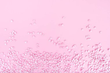 Pink background. Pink hearts on a pink background. Hearts sprinkles. Valentine day.