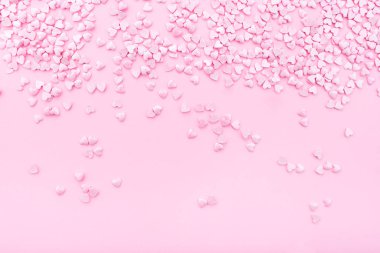 Pink background. Pink hearts on a pink background. Hearts sprinkles. Valentine day.