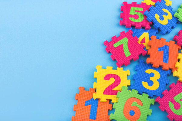 Colorful kids numbers toys on blue background. Education concept. Creative concept. Flat lay, copy space, top view.