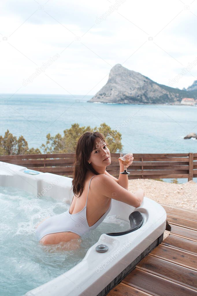Beautiful girl relaxing in bathroom with a beautiful view. Beautiful spa. Summer vacation. Spa Relax.