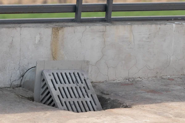 Square steel terrace water drain cover or grating installed.