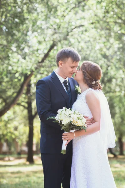 Couple mariée et marié sur un fond de parc — Photo