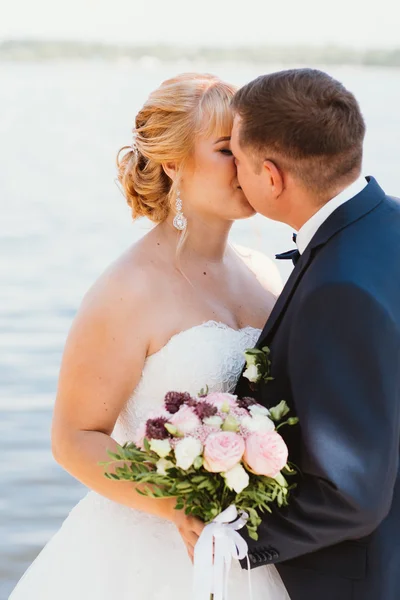 Bride and groom on the background of the river — Stock Photo, Image