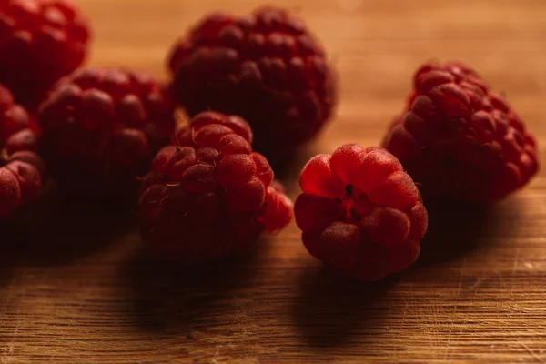 Raspberry on a blurred background of wooden planks — Stock Photo, Image