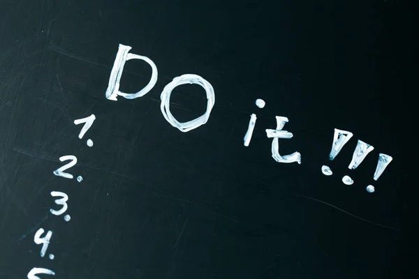 Inscription do it list drawn with chalk on a school blackboard dark — Stock Photo, Image