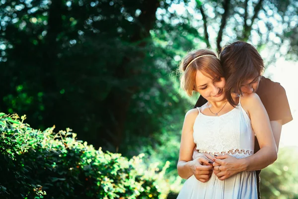 Ragazzo e la ragazza abbracciando su uno sfondo di parco — Foto Stock