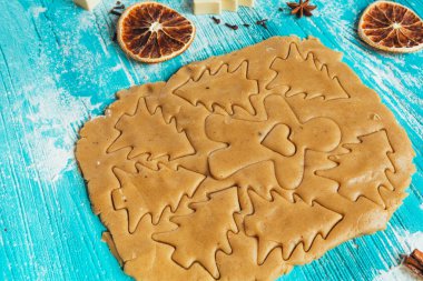 Zencefilli kurabiye hamuru ile tarçın mavi ahşap masa üzerinde pişirme için kalıplar