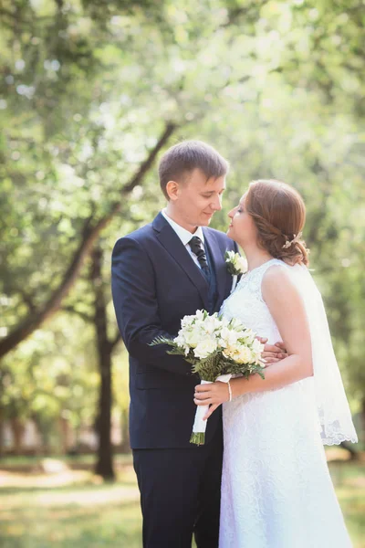 Couple bride and groom on a park background — Stock Photo, Image