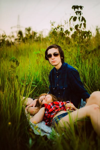 Guy and the girl sitting in the grass — Stock Photo, Image