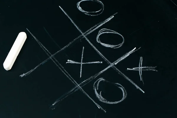 Tic tac toe chalk on a  school blackboard dark — Stock Photo, Image