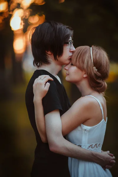 Killen och tjejen embracing på en bakgrund av naturpark — Stockfoto