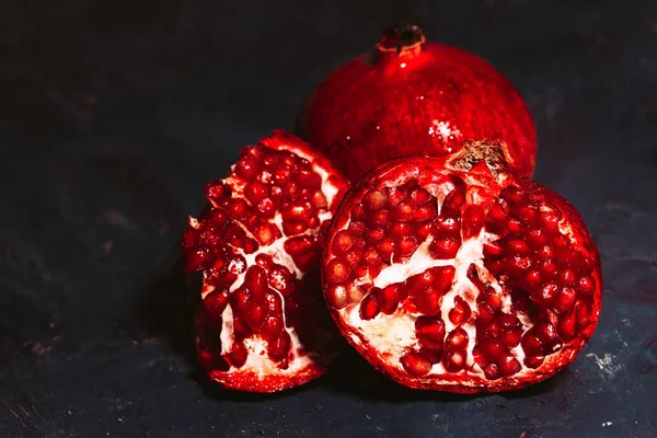 Red sliced pomegranate on a blue abstraction background — Stock Photo, Image