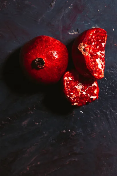 Red sliced pomegranate on a blue abstraction background — Stock Photo, Image