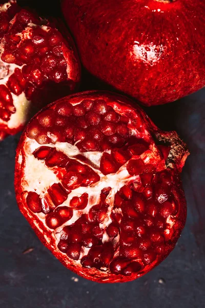 Red sliced pomegranate on a blue abstraction background — Stock Photo, Image