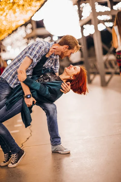 Pareja feliz abrazándose en la noche en una guirnalda de luz —  Fotos de Stock