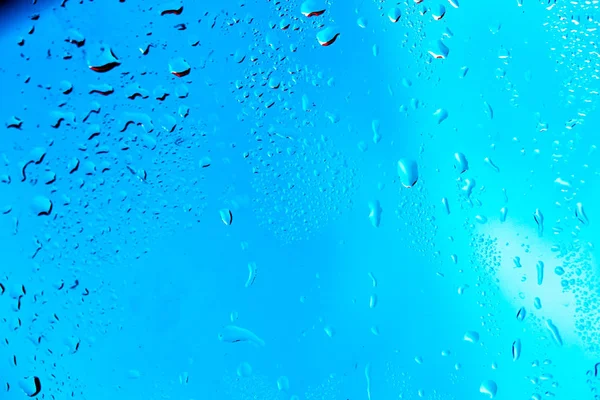 Gotas en el fondo azul de la lluvia de vidrio —  Fotos de Stock