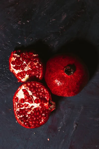 Red sliced pomegranate on a blue abstraction background — Stock Photo, Image