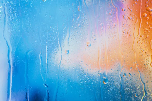 Bulanık çok renkli arka plan üzerinde yağmur damlaları — Stok fotoğraf