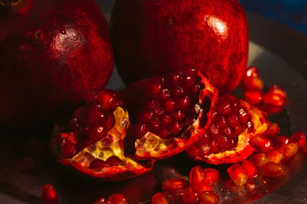 Red pomegranate on metal a plate — Stock Photo, Image