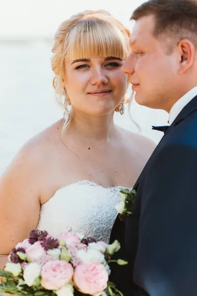 Bride and groom on the background of the river — Stock Photo, Image