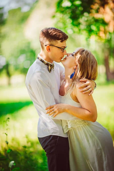 Young beautiful couple on a blurred natural background — Stock Photo, Image