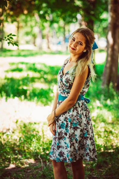 Young beautiful girl in floral dress — Stock Photo, Image
