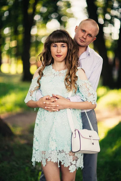 Beautiful young couple on the park background — Stock Photo, Image