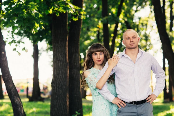 Beautiful young couple on the park background — Stock Photo, Image