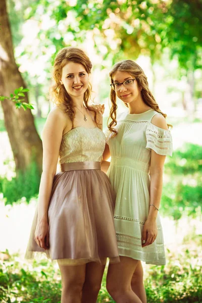 Two beautiful girlfriends on a plant background — Stock Photo, Image