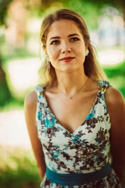 Young beautiful girl in floral dress — Stock Photo, Image