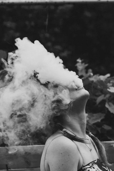 Girl and vapour on a dark background — Stock Photo, Image