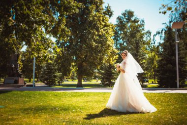 Parkta yürüyen güzel esmer gelin.