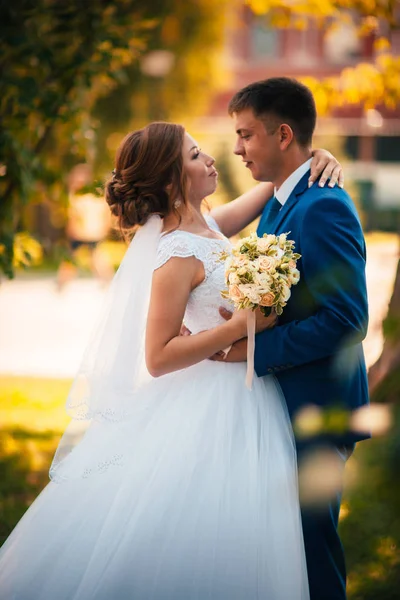 Couple marié et mariée sur le fond de feuilles d'orange — Photo