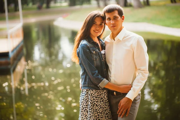 Beautiful young couple on the lake background — Stock Photo, Image
