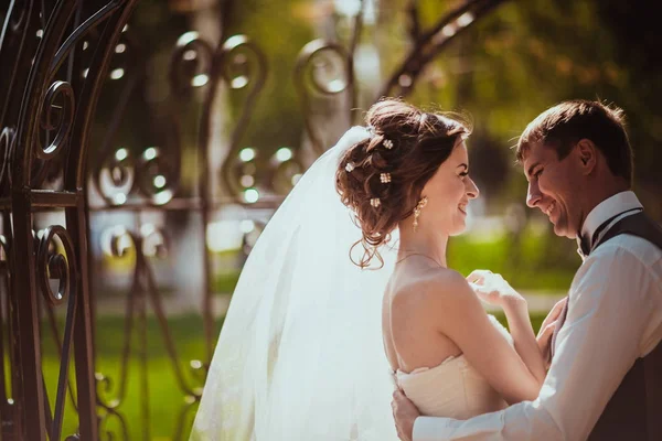 Жених и невеста в парковой арке — стоковое фото