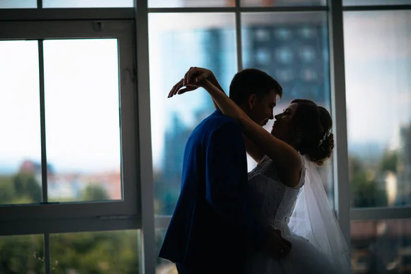 Bride and groom on background clear windows — Stock Photo, Image