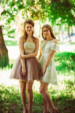 Bitki arka planında iki güzel kız arkadaş.