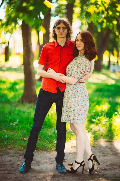 Beautiful young couple on the park background — Stock Photo, Image