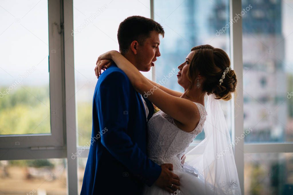 bride and groom on background clear windows