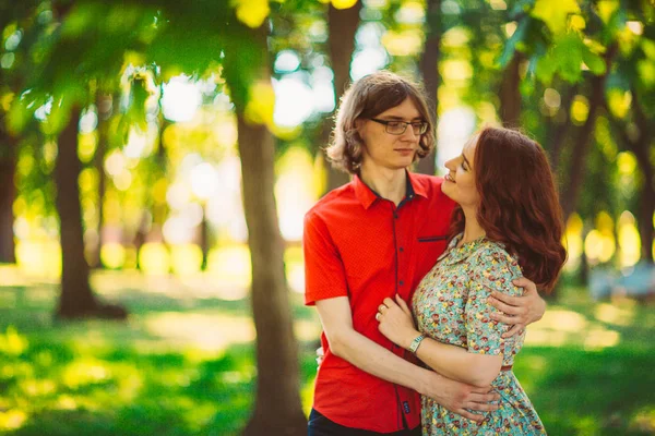 Beautiful young couple on the park background — Stock Photo, Image