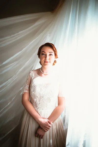 Portrait of a beautiful young bride near the window — Stock Photo, Image