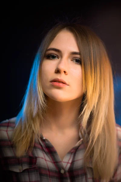 Portrait smiling girl on blue background in studio — Stock Photo, Image