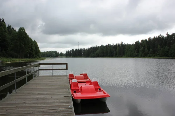 Beautiful calm lake landscape with a catamaran — Stock Photo, Image