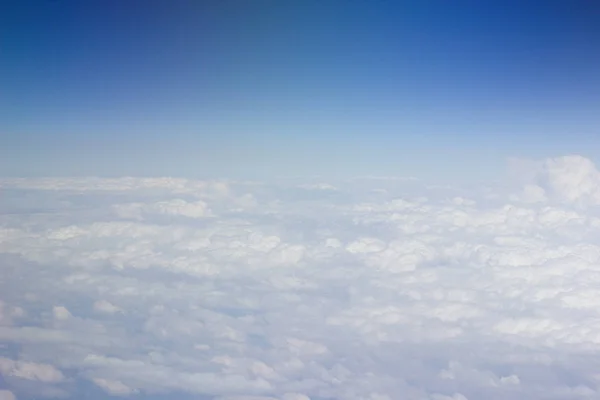 Nuvens brancas no céu são fotografadas no auge do voo da aeronave — Fotografia de Stock