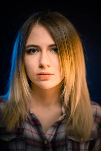 Portrait smiling girl on blue background in studio — Stock Photo, Image