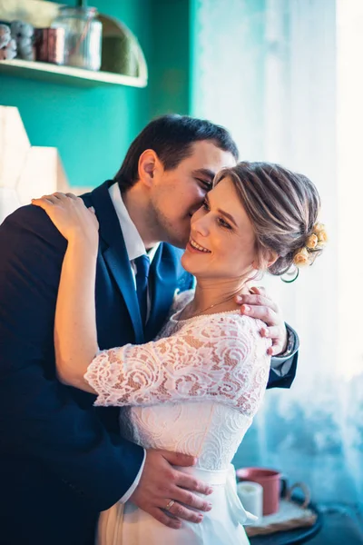 Couple groom and bride in light studio — Stock Photo, Image