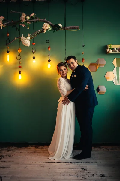 Couple groom and bride in light studio — Stock Photo, Image