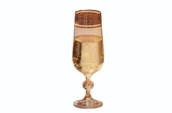 Two wine glasses filled with champagne, and candles. — Stock Photo, Image