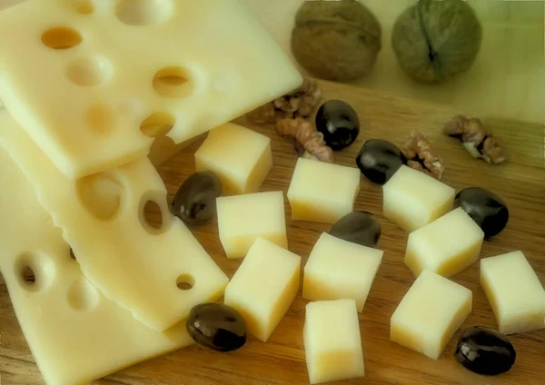 Cheese and walnuts on a plate. — Stock Photo, Image