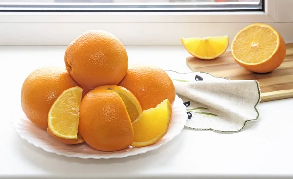 Windowsill Plate Large Oranges Some Them Cut Slices — Stock Photo, Image